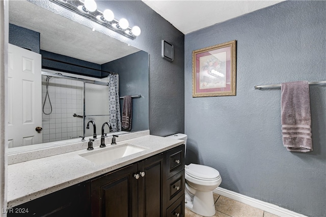 bathroom featuring toilet, vanity, tile patterned floors, and curtained shower