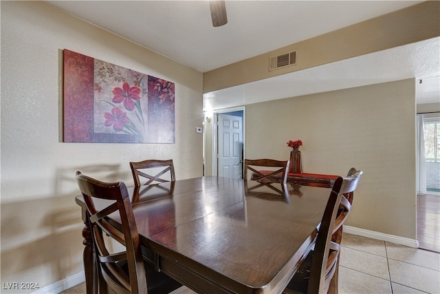 dining space featuring light tile patterned floors and ceiling fan