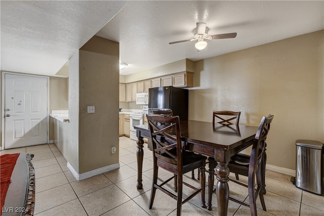 tiled dining space featuring ceiling fan and a textured ceiling