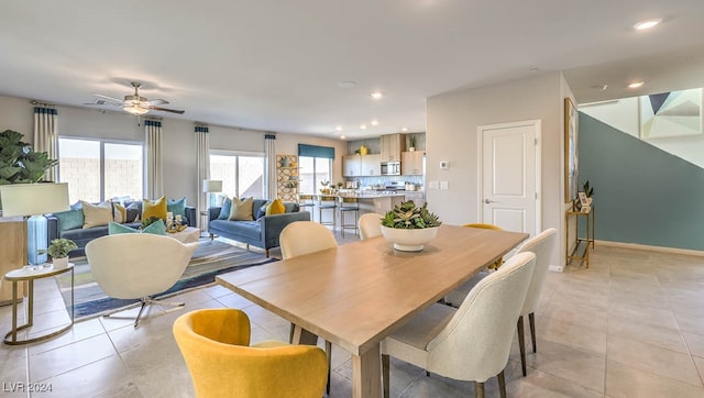 tiled dining space with ceiling fan