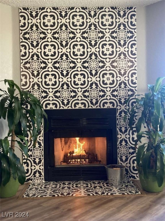 details with a textured ceiling and hardwood / wood-style flooring