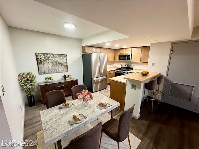 kitchen featuring dark wood-type flooring and appliances with stainless steel finishes