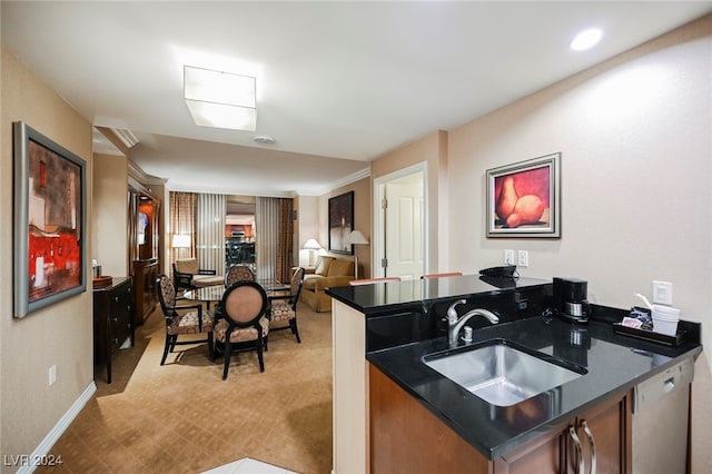 kitchen with kitchen peninsula, light carpet, crown molding, sink, and dishwasher