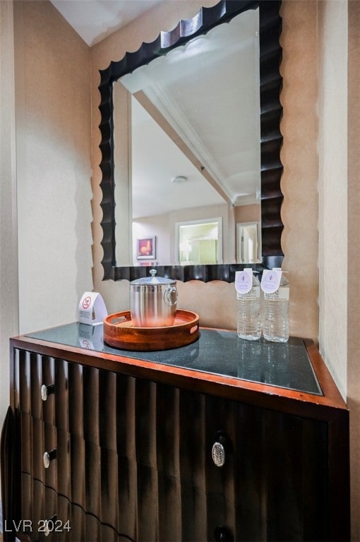 bathroom with vanity and ornamental molding