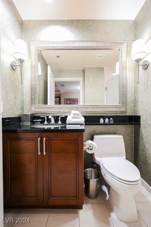 bathroom featuring tile patterned flooring, vanity, and toilet