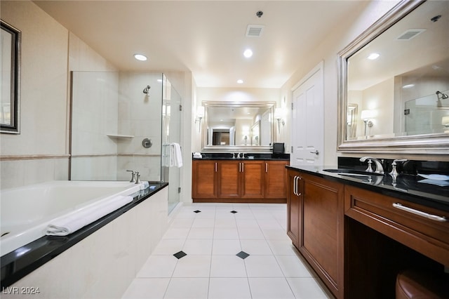 bathroom with tile patterned floors, vanity, and separate shower and tub