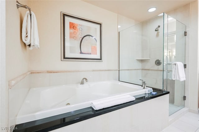 bathroom featuring tile patterned floors and independent shower and bath