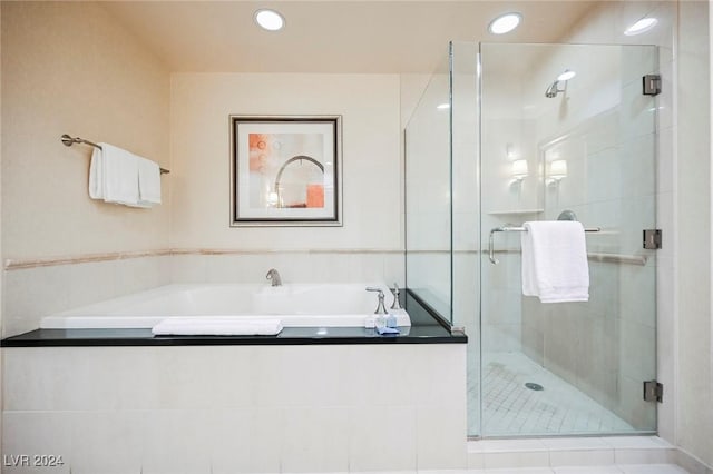145 Harmon Ave Unit 208, Las Vegas, NV 89109 - full bathroom featuring a bath, a shower stall, recessed lighting, and tile patterned floors