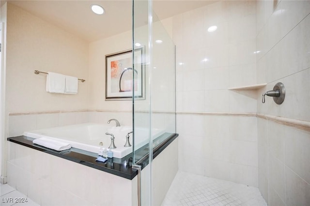 145 Harmon Ave Unit 208, Las Vegas, NV 89109 - bathroom with a stall shower, a garden tub, and tile patterned floors