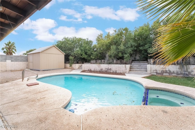 view of pool featuring a storage unit and an in ground hot tub