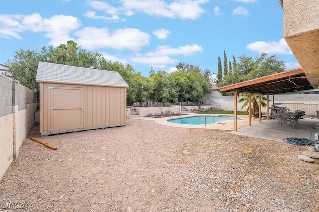 view of swimming pool with a patio area, grilling area, and a storage shed