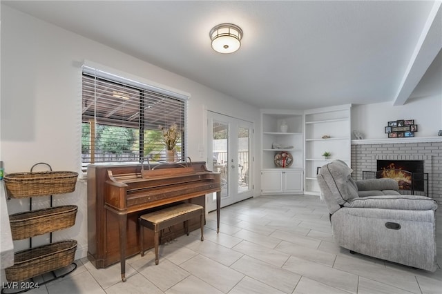 living room featuring french doors and a brick fireplace