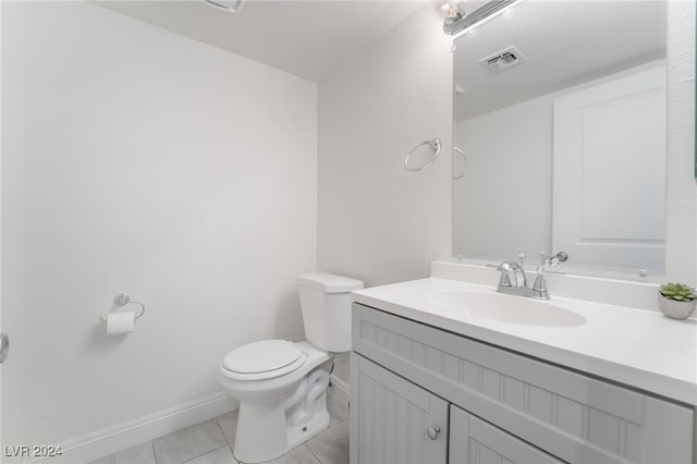 bathroom featuring tile patterned floors, vanity, and toilet