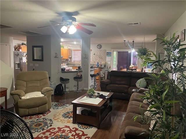 living room with ceiling fan and dark hardwood / wood-style flooring