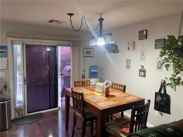 dining area with plenty of natural light and dark hardwood / wood-style floors