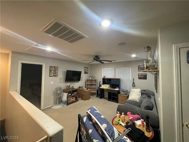 carpeted living room with ceiling fan