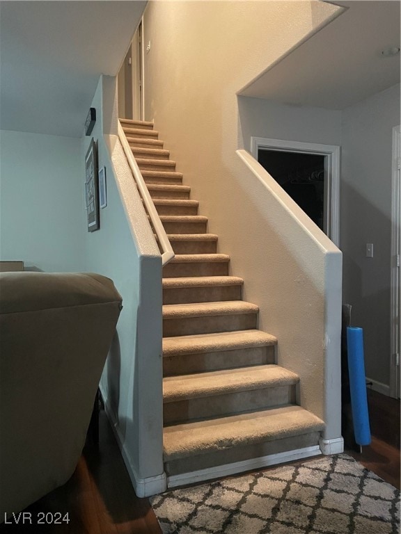 stairs with hardwood / wood-style floors