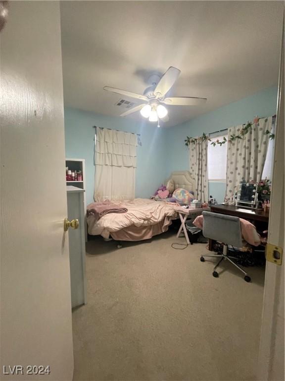 carpeted bedroom with ceiling fan