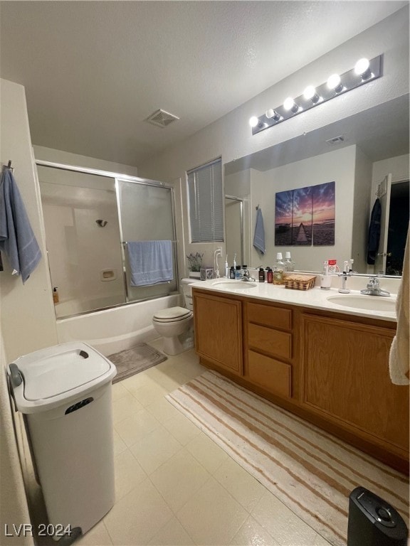 full bathroom with shower / bath combination with glass door, toilet, and vanity