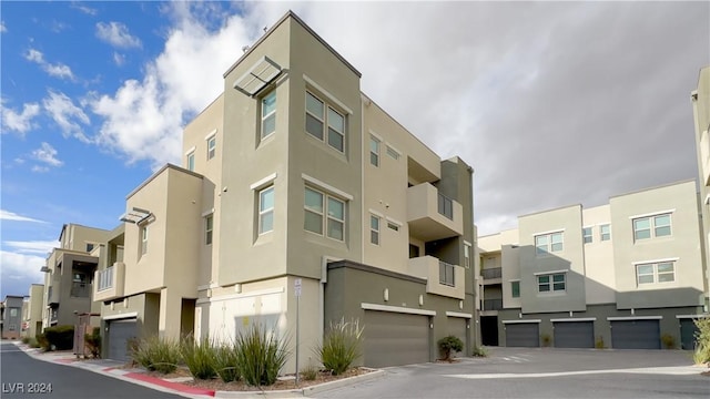 view of property featuring an attached garage and a residential view