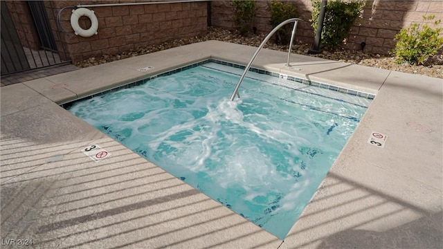 view of pool featuring fence