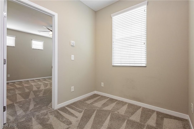 carpeted empty room with baseboards