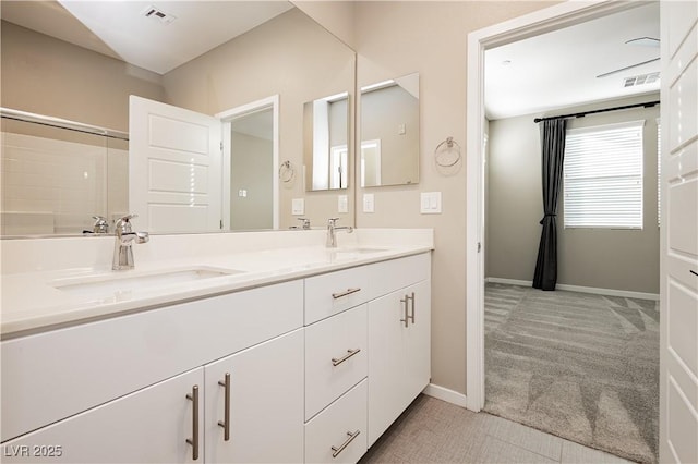 bathroom featuring double vanity, visible vents, and a sink