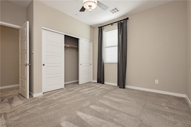 unfurnished bedroom featuring a closet, ceiling fan, and light colored carpet