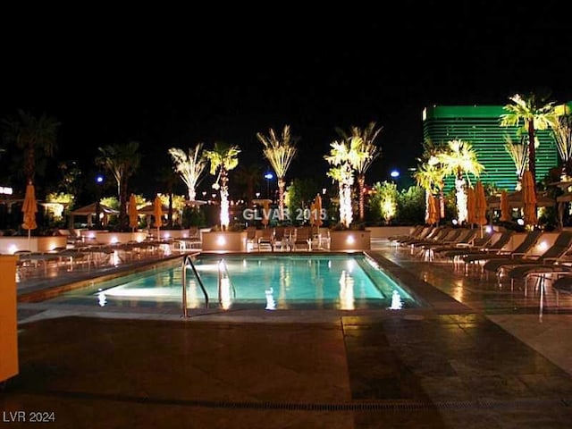 pool at night with a patio