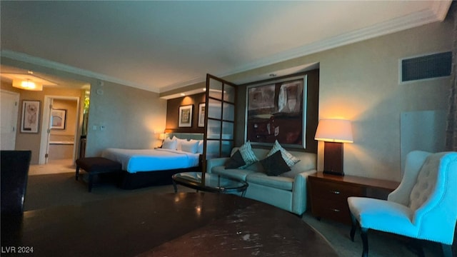 bedroom featuring crown molding and ensuite bath