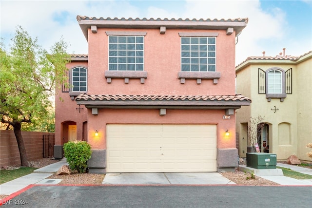 mediterranean / spanish house featuring central AC unit and a garage