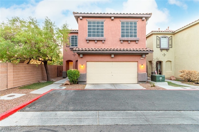 mediterranean / spanish-style house with central AC and a garage