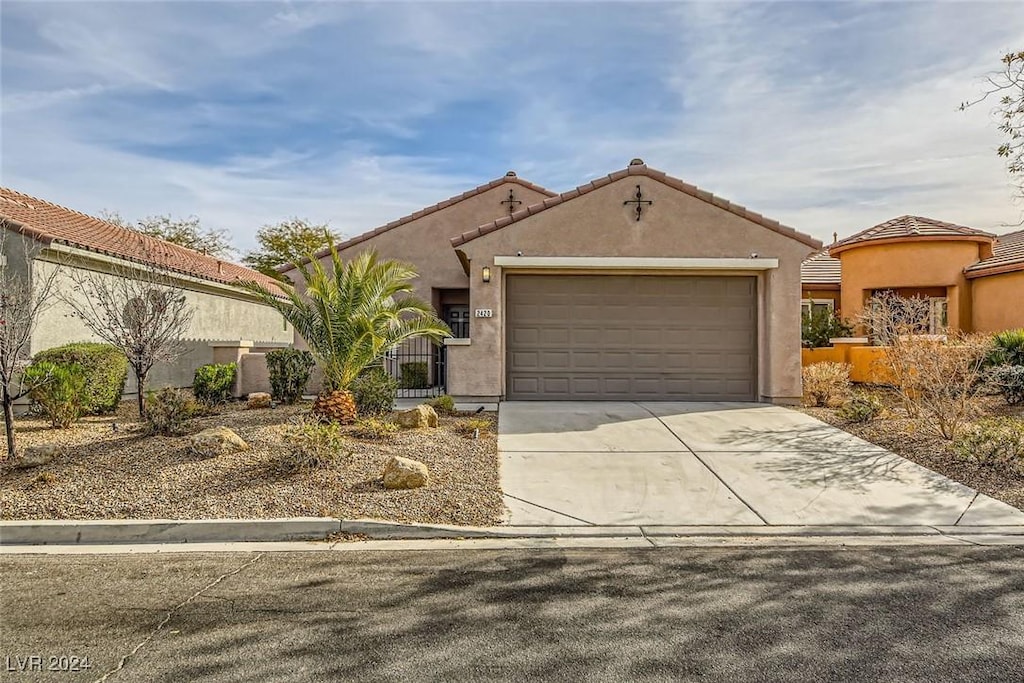 mediterranean / spanish house featuring a garage