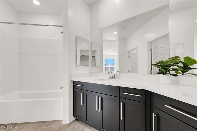 bathroom featuring tile patterned floors, vanity, and  shower combination