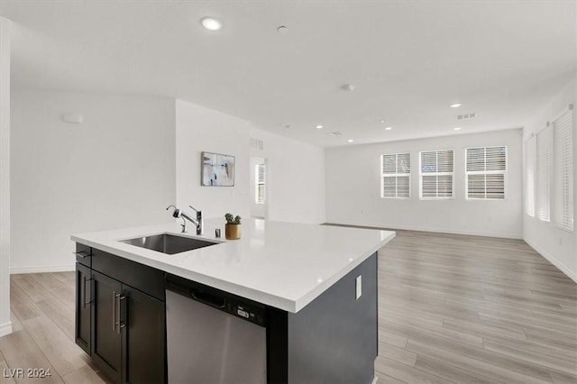 kitchen with dishwasher, a healthy amount of sunlight, sink, and a kitchen island with sink