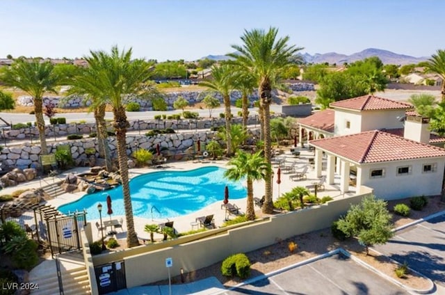 view of swimming pool featuring a mountain view and a patio area