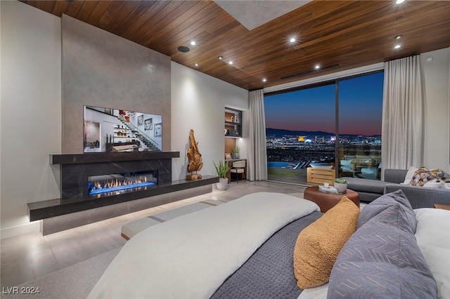 living room featuring wood ceiling and a tile fireplace