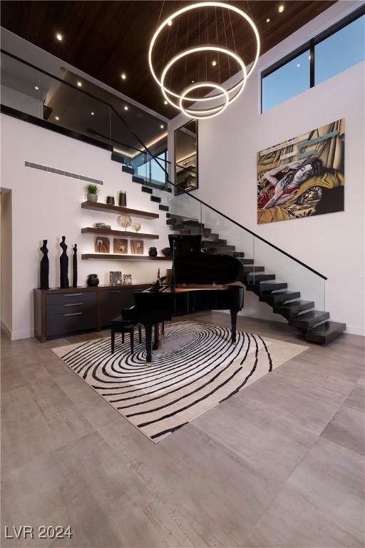 misc room with a high ceiling and an inviting chandelier