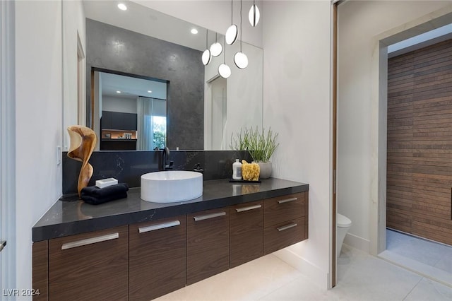 bathroom featuring tile patterned flooring, vanity, and toilet