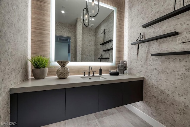 bathroom with tile patterned floors, vanity, and a chandelier