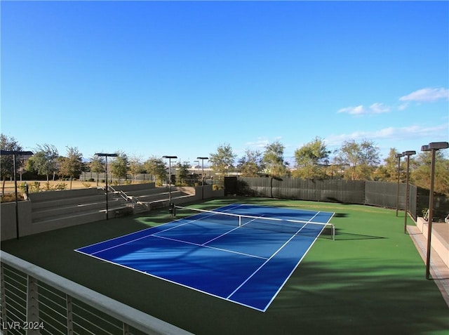 view of tennis court featuring basketball hoop