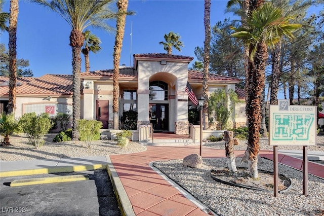 view of front of house with a tiled roof and stucco siding