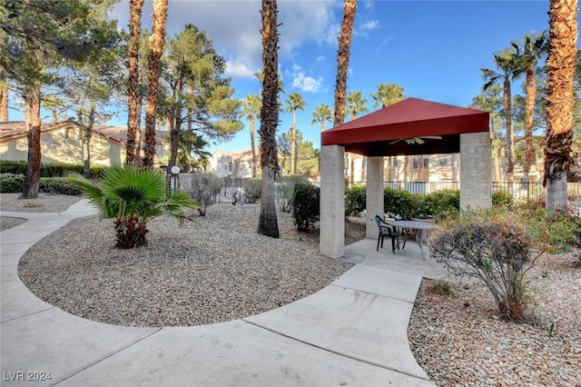 surrounding community with fence, a gazebo, and a patio