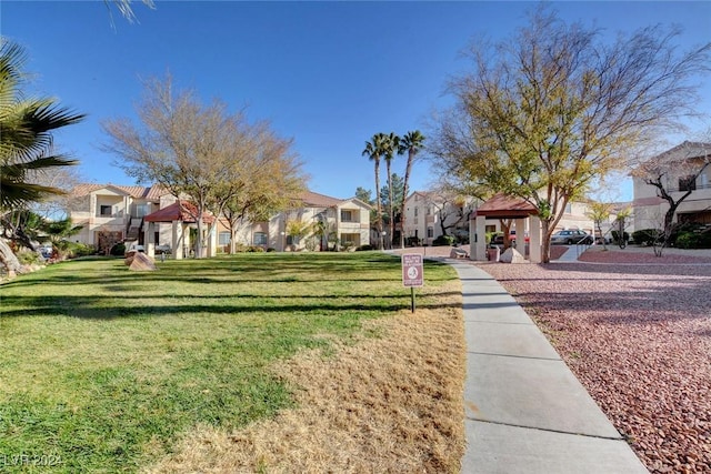 exterior space with a residential view, a yard, and a gazebo