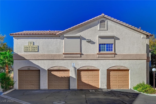 mediterranean / spanish-style house featuring a tiled roof and stucco siding