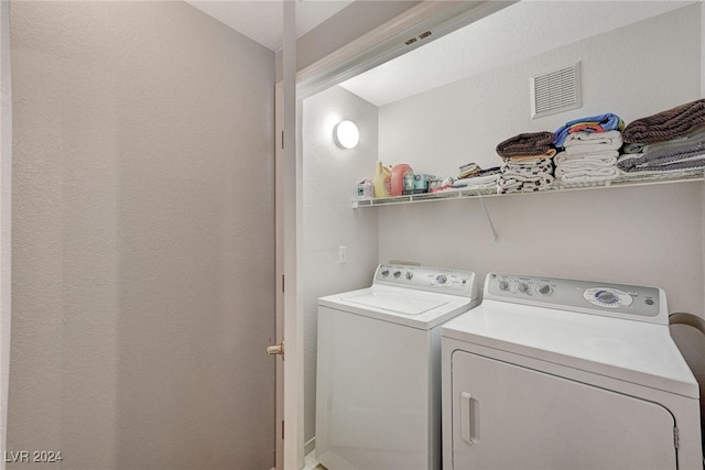 laundry area featuring washing machine and dryer, laundry area, and visible vents