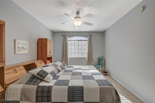 bedroom with ceiling fan, baseboards, and light colored carpet