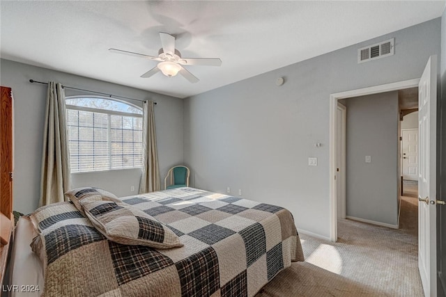 carpeted bedroom featuring visible vents, ceiling fan, and baseboards