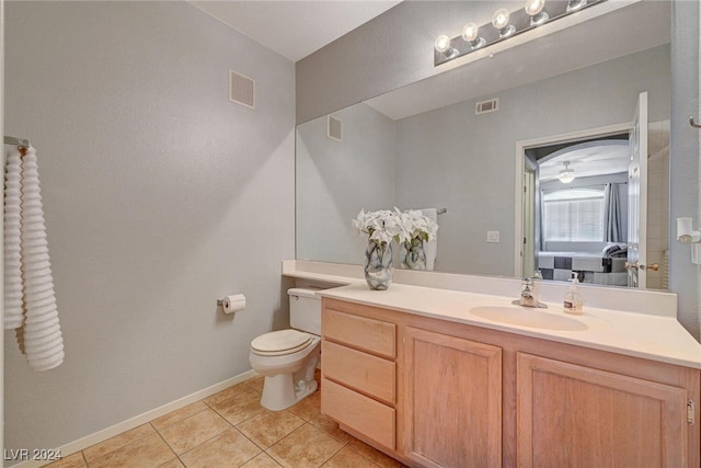 bathroom featuring visible vents, vanity, toilet, and tile patterned floors