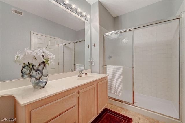 full bath featuring a stall shower, tile patterned flooring, visible vents, and vanity